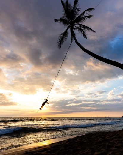 Palm tree swing above ocean at Dalawella Beach, Unawatuna, Sri Lanka,